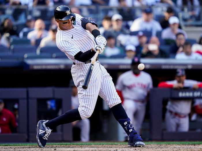 New York Yankees’ Aaron Judge hits a double in the ninth inning of an opening day baseball game against the Boston Red Sox, Friday, April 8, 2022, in New York.